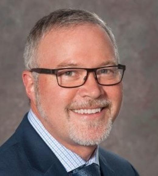 A person smiling for a picture. Picture of Professor John D. McPherson.