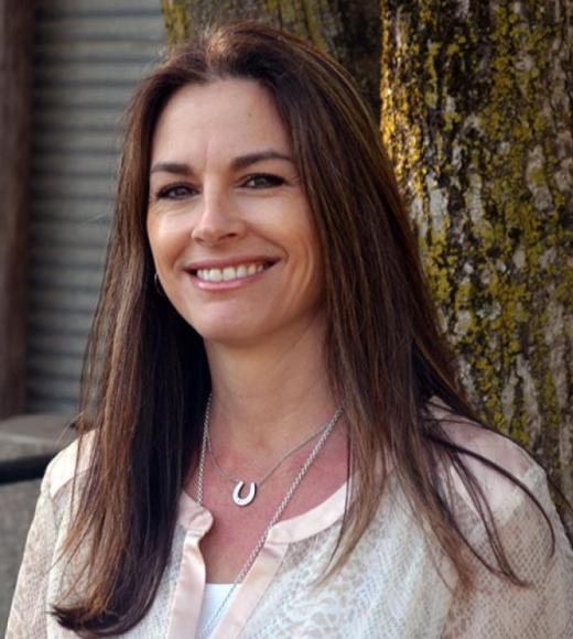 A person smiling for a picture. Picture of Michelle Belden.
