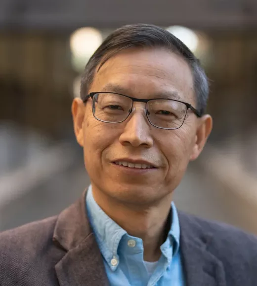 A person smiling for a picture. Picture of Professor Huaijun Zhou.
