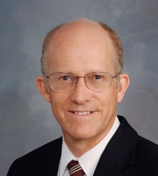 A person smiling for a picture. Picture of Prof. Ken Burtis.