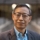 A person smiling for a picture. Picture of Professor Huaijun Zhou.